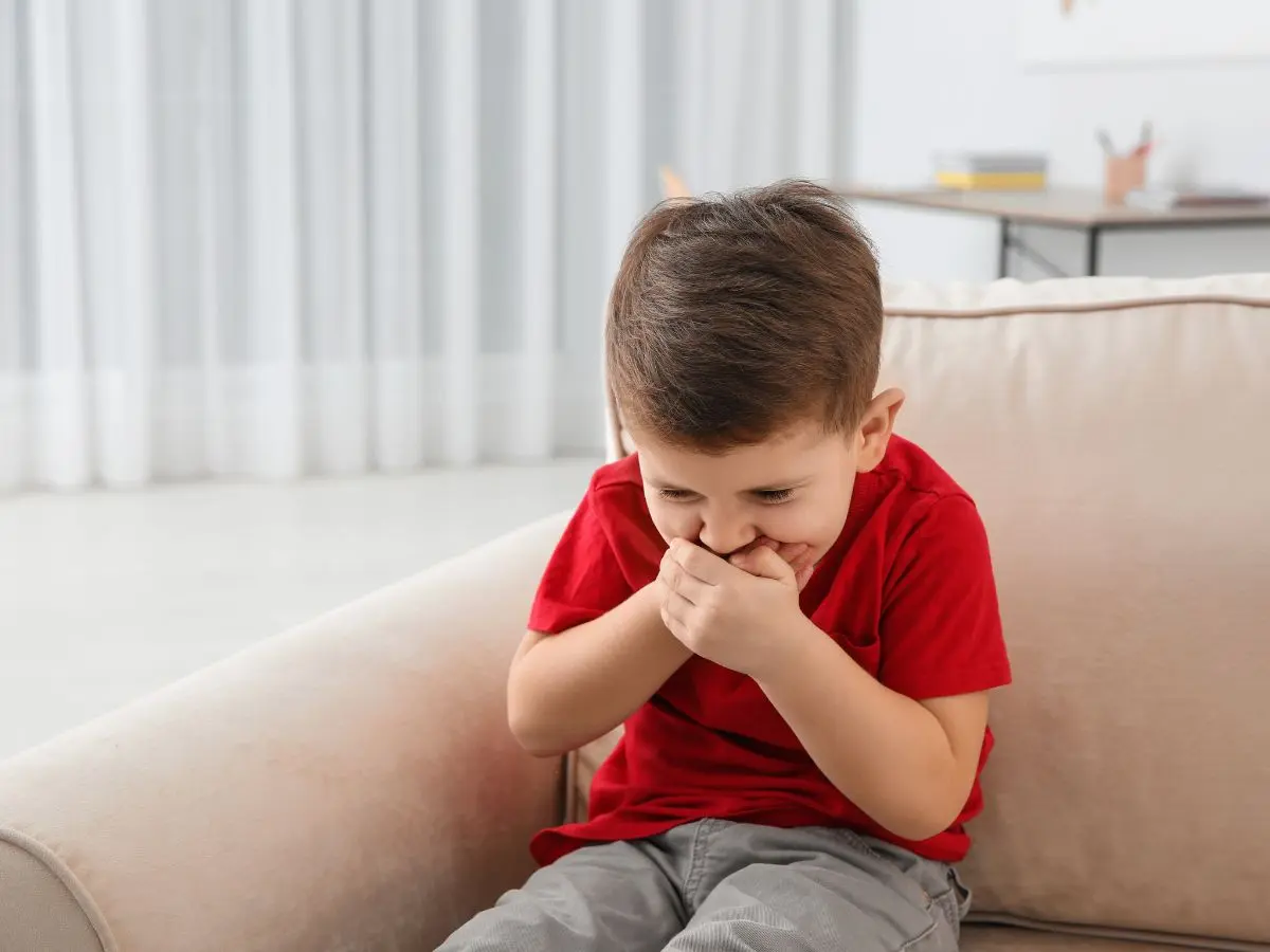 Kid vomiting onto carpet