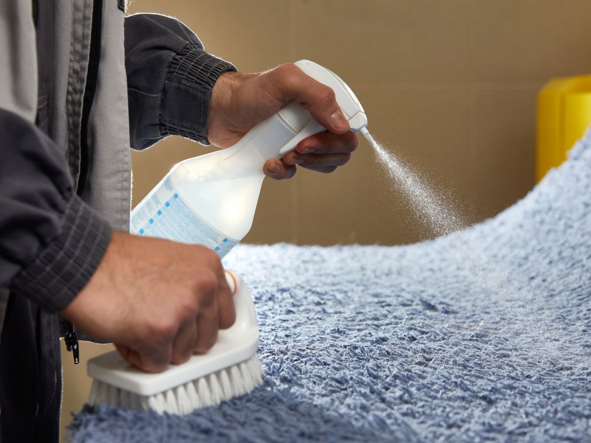 applying spray to a blanket to remove stain