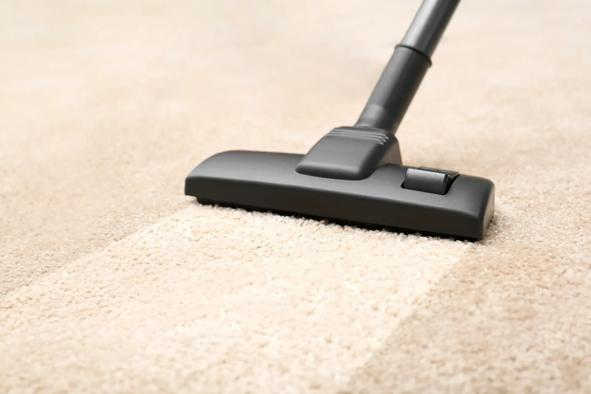 vacuuming carpet to remove allergens